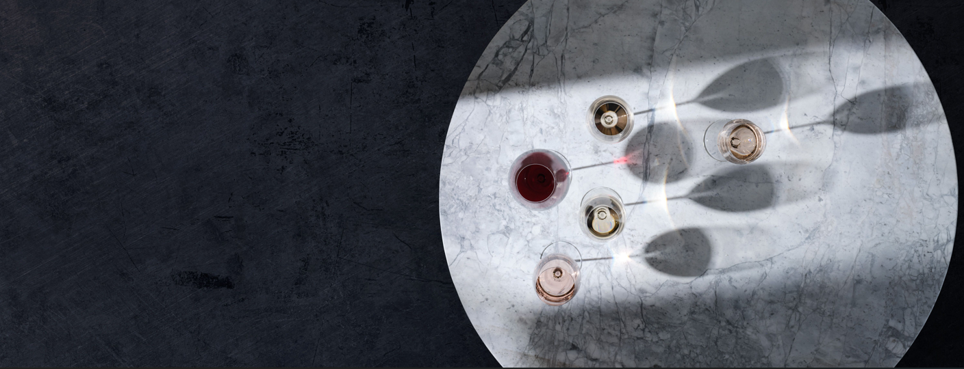 Close-up of a metallic surface with circular components and a red liquid droplet.